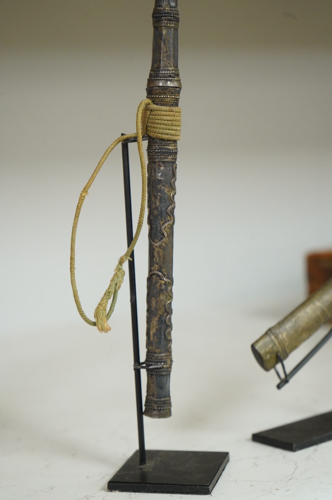 A Burmese dagger dha, blade 14.5cm, hilt and sheath covered in sheet silver filigree decoration, together with an unusual pair of small Burmese knives with silver mounted stag horn handles and silver covered sheath, both